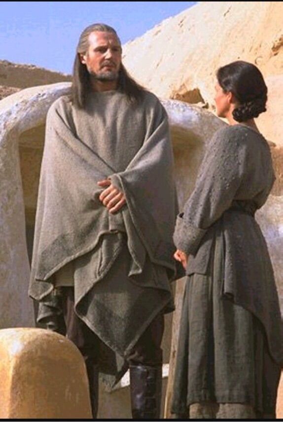 Liam Neeson as Jedi Master Qui-Gon Jinn standing with Pernilla August as Shmi Skywalker 